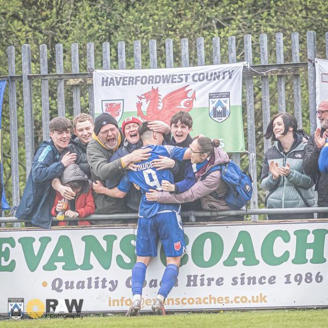 Ben Fawcett celebrates with Haverfordwest County supporters after he added the third goal